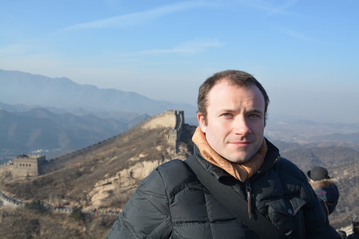 Standing in front of the Great Wall of China.